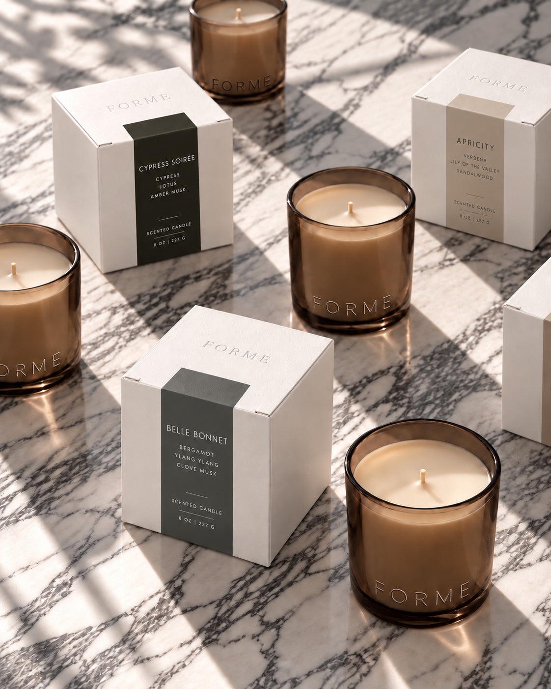 FORME 8 oz candles and scent boxes on marble